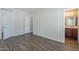 View of the main bedroom revealing wood floors, ensuite bathroom, and closets at 11625 N 153Rd Dr, Surprise, AZ 85379