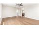 Spacious and bright bedroom featuring modern ceiling fan, hardwood flooring, and a view into the attached bathroom at 11891 N 147Th Dr, Surprise, AZ 85379