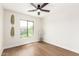 Bedroom with a ceiling fan and large window offering beautiful exterior views at 11891 N 147Th Dr, Surprise, AZ 85379