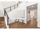 Bright foyer featuring hardwood floors, staircase with iron railing, and view to living area at 11891 N 147Th Dr, Surprise, AZ 85379