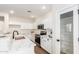 Bright kitchen features white cabinets, marble countertops, stainless steel appliances, and modern faucet at 11891 N 147Th Dr, Surprise, AZ 85379