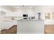 Modern kitchen with white cabinets, stainless steel appliances, and a countertop dining area at 11891 N 147Th Dr, Surprise, AZ 85379