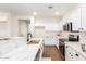 Well-lit kitchen with white cabinets, a modern faucet, and a breakfast bar perfect for casual dining and entertaining at 11891 N 147Th Dr, Surprise, AZ 85379