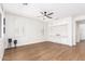 Spacious living room with white trim, light hardwood floors, and built in display case at 11891 N 147Th Dr, Surprise, AZ 85379