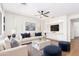 Inviting living room featuring a neutral color palette, plush seating, built-in shelving, and modern ceiling fan at 11891 N 147Th Dr, Surprise, AZ 85379