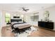 Elegant main bedroom features a dark ceiling fan, a king-size bed with stylish decor, and hardwood flooring at 11891 N 147Th Dr, Surprise, AZ 85379