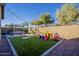 Expansive backyard with artificial turf, patio, and play area, designed for entertainment at 13140 W Rowel Rd, Peoria, AZ 85383