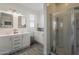 Bright bathroom with double sink vanity, modern fixtures, and a glass shower enclosure at 13140 W Rowel Rd, Peoria, AZ 85383