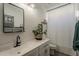Stylish bathroom featuring a plant, modern fixtures, and a shower with a white curtain at 13140 W Rowel Rd, Peoria, AZ 85383