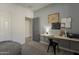Cozy bedroom with a built-in desk, stylish decor, and a connecting door to the ensuite bathroom at 13140 W Rowel Rd, Peoria, AZ 85383