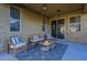 Cozy covered patio offers comfortable seating, stylish rug, and convenient access to the home at 13140 W Rowel Rd, Peoria, AZ 85383