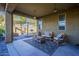 Inviting covered patio featuring stylish seating, a modern rug, and an outdoor swing at 13140 W Rowel Rd, Peoria, AZ 85383