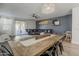 Open-concept dining room boasts a stylish table, industrial chairs, and seamless flow to the living area at 13140 W Rowel Rd, Peoria, AZ 85383