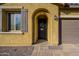 Inviting front entryway with dark door, shutters, desert landscaping and a charming tiled walkway at 13140 W Rowel Rd, Peoria, AZ 85383