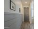 Hallway showcasing gray paneled walls, modern flooring, and access to various rooms at 13140 W Rowel Rd, Peoria, AZ 85383