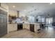 Open kitchen with stainless appliances, floating shelves, and a view of the dining area at 13140 W Rowel Rd, Peoria, AZ 85383
