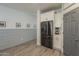 Kitchen view with modern stainless steel refrigerator and sleek white cabinets at 13140 W Rowel Rd, Peoria, AZ 85383