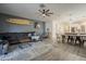 Bright living space featuring a comfortable sectional sofa, surfboard decor, and easy access to the dining area at 13140 W Rowel Rd, Peoria, AZ 85383