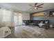Inviting living room features a cozy sectional sofa, surfboard decor, and seamless access to the outdoor patio at 13140 W Rowel Rd, Peoria, AZ 85383