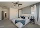 Bright and spacious main bedroom with soft carpet, an ensuite bathroom, and ample natural light at 13140 W Rowel Rd, Peoria, AZ 85383