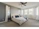 Bright, spacious main bedroom featuring large windows, neutral carpet, and a stylish bed at 13140 W Rowel Rd, Peoria, AZ 85383