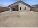 Low-maintenance backyard with a covered patio and desert landscaping, ideal for outdoor entertaining at 14065 W Cornerstone Trl, Surprise, AZ 85374