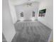 Spacious bedroom with neutral carpeting, a ceiling fan, and bright natural light from two well-placed windows at 14065 W Cornerstone Trl, Surprise, AZ 85374