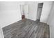 Bedroom featuring wood-style tile floors, natural light, and closet space at 14065 W Cornerstone Trl, Surprise, AZ 85374