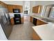 Functional kitchen featuring stainless steel appliances, light countertops, and ample cabinet space at 14065 W Cornerstone Trl, Surprise, AZ 85374