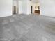 Large main bedroom featuring plush carpeting, natural light, and a full bathroom at 14065 W Cornerstone Trl, Surprise, AZ 85374
