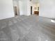 Bright main bedroom with new carpet, ensuite bath, and vaulted ceiling at 14065 W Cornerstone Trl, Surprise, AZ 85374