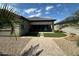 Backyard featuring artificial grass, desert landscaping and covered patio at 15301 W Moreland St, Goodyear, AZ 85338