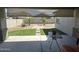 Cozy covered patio overlooking a landscaped backyard with artificial turf and pavers at 15301 W Moreland St, Goodyear, AZ 85338