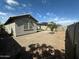 View of the backyard with rock landscaping, artificial grass, and privacy wall at 15301 W Moreland St, Goodyear, AZ 85338