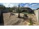 Landscaped backyard featuring desert plants, gravel, and artificial turf at 15301 W Moreland St, Goodyear, AZ 85338