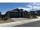 A well kept exterior with xeriscape landscaping, pavers and tile roof under a partly cloudy sky at 15301 W Moreland St, Goodyear, AZ 85338