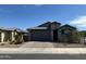 Charming single-story home featuring desert landscaping, a brick driveway and tile roof at 15301 W Moreland St, Goodyear, AZ 85338