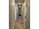 Hallway view of the bedroom and bath with a tiled floor at 15301 W Moreland St, Goodyear, AZ 85338
