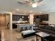 Open-concept kitchen and living space boasting a granite island, dark wood cabinets, and modern appliances at 15301 W Moreland St, Goodyear, AZ 85338