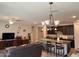 Cozy living room adjacent to the kitchen with tile floors, dark wood accents and ample lighting at 15301 W Moreland St, Goodyear, AZ 85338