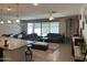 Open-concept living space featuring tile flooring, a large sectional couch and lots of natural light at 15301 W Moreland St, Goodyear, AZ 85338