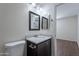 Updated bathroom featuring dark vanity with granite countertop, modern fixtures, and tile flooring at 15725 W Lundberg St, Surprise, AZ 85374