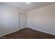Neutral bedroom featuring wood-look floors and spacious closets at 15725 W Lundberg St, Surprise, AZ 85374