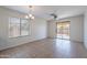 Bright dining area with ceramic tile floors, modern light fixtures, and sliding glass door to the backyard at 15725 W Lundberg St, Surprise, AZ 85374