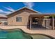 Back exterior view of home with covered patio and view of the pool at 15725 W Lundberg St, Surprise, AZ 85374
