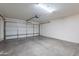Spacious garage with automatic door and ample room for vehicles and storage, plus concrete floors at 15725 W Lundberg St, Surprise, AZ 85374