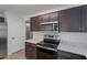 A close up of the kitchen featuring dark cabinets and modern, stainless steel appliances at 15725 W Lundberg St, Surprise, AZ 85374
