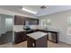 Kitchen with dark cabinets, granite countertops, stainless steel appliances, and tile floor at 15725 W Lundberg St, Surprise, AZ 85374