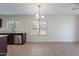 Well-lit kitchen area featuring stainless steel appliances and granite countertops with tile flooring at 15725 W Lundberg St, Surprise, AZ 85374