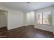 Living room features wood-look floors, neutral walls, and a white front door at 15725 W Lundberg St, Surprise, AZ 85374